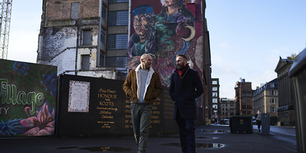 Two men walking through Merchant City